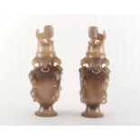 A pair of Chinese carved grey agate vases & covers, with temple lion finials & ring handles, each