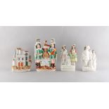 Property of a lady - a group of four Victorian Staffordshire figures including a clock group, the