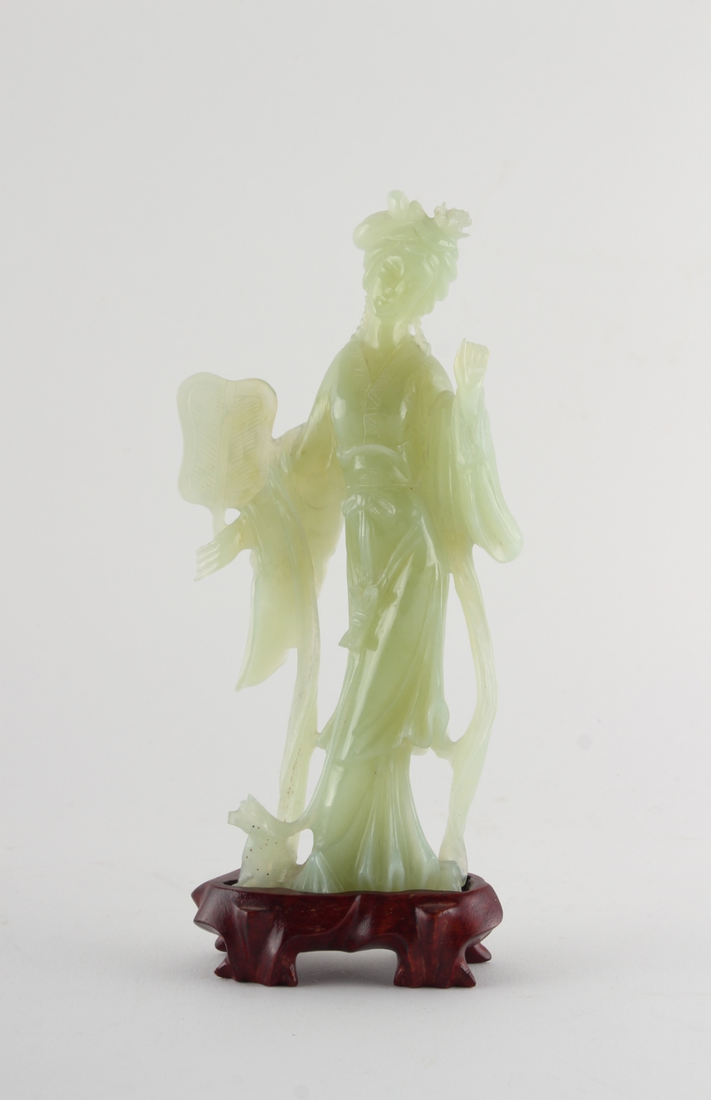 Property of a deceased estate - a Chinese carved bowenite figure of Guanyin, on fitted wooden stand,