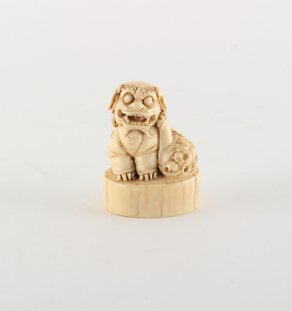 Property of a gentleman - a Chinese carved ivory chop seal modelled as a seated Buddhistic lion,