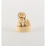 Property of a gentleman - a Chinese carved ivory chop seal modelled as a seated Buddhistic lion,