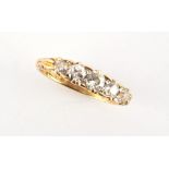 A late 19th / early 20th century 18ct yellow gold diamond five stone ring, with carved setting,