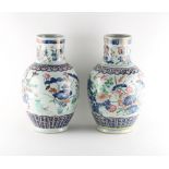 Two very similar late 19th century Chinese famille rose vases, painted with birds among flowering