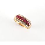 An 18ct yellow gold ruby & diamond ring, set with a row of six oval cushion cut rubies weighing