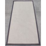 Property of a gentleman - a modern jute mat, 157 by 75ins. (399 by 191cms.).