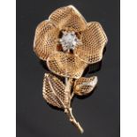 An unusual 18ct yellow gold diamond floral spray brooch, the flowerhead with hinged folding petals