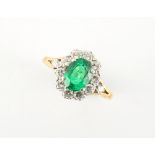 An 18ct yellow gold emerald & diamond oval cluster ring, the vibrant & clear oval cushion cut