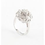 An 18ct white gold diamond cluster ring, with nine round brilliant cut diamonds, the estimated total