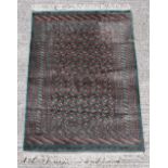 Property of a gentleman - a good quality Tekke design hand knotted rug with green ground, 71 by