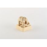 Property of a gentleman - a Chinese carved ivory square seal modelled as a seated tiger, early