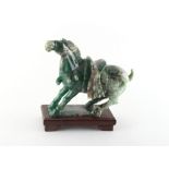 Property of a gentleman - a Chinese Tang style carved nephrite jade model of a caparisoned horse,