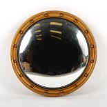 Property of a gentleman - a gilt circular framed convex mirror, first half 20th century, 21.5ins. (