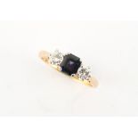 An 18ct yellow gold sapphire & diamond three stone ring, the octagonal cut sapphire weighing