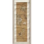 A late 19th / early 20th century Chinese scroll painting on silk depicting two birds among blossomin
