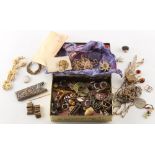 A small tin containing assorted costume jewellery, etc..