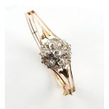 A late 19th century yellow gold diamond cluster hinged bangle, set with Old European & rose cut