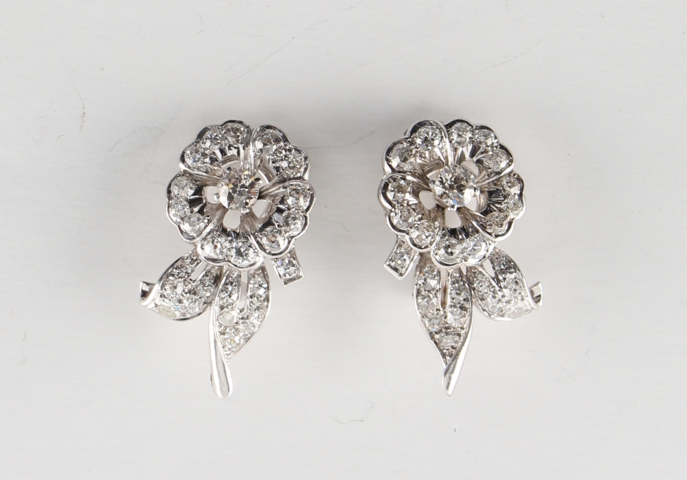 A pair of white gold diamond floral earrings, with clip fastenings, the estimated total diamond