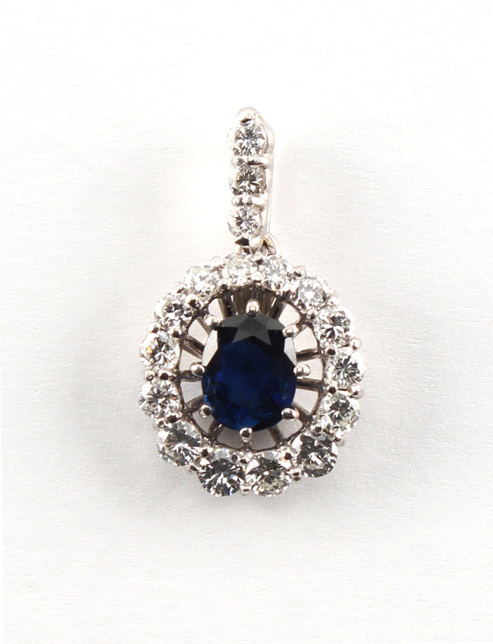 An 18ct white gold sapphire & diamond pendant, the oval cut sapphire weighing approximately 1.45