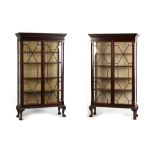 A pair of Edwardian Chippendale style mahogany china display cabinets, each with a dentil cornice