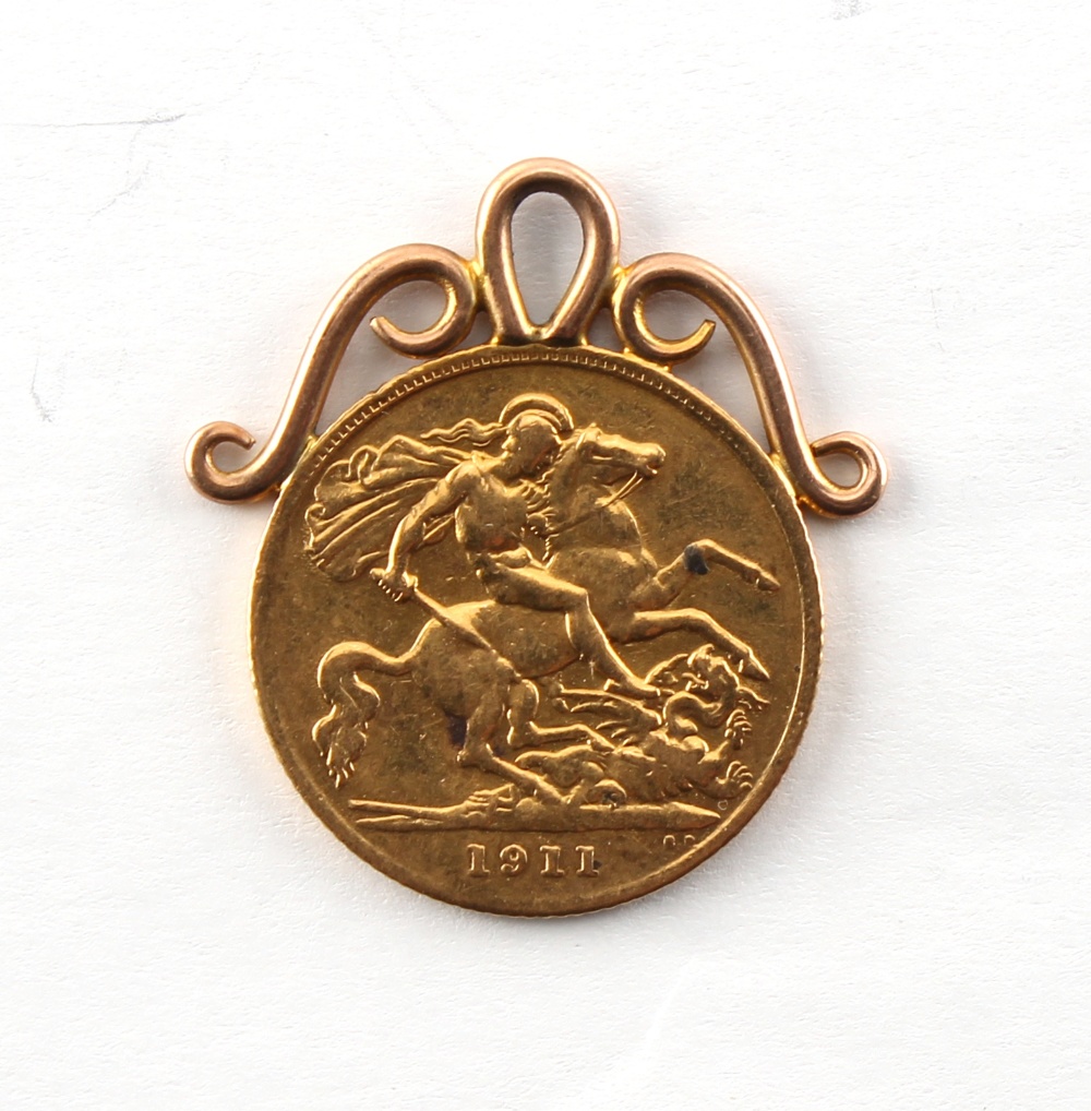 A 1911 George V gold half sovereign coin pendant, approximately 4.7 grams.