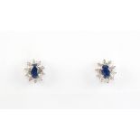 A pair of sapphire & diamond oval cluster earrings, with post & butterfly fastenings, each