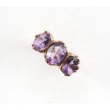 A 9ct gold ring set with three oval cut amethysts, size N, boxed.
