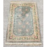 A Chinese hand knotted wool Chinese carpet with green ground, 97 by 66ins. (246 by 167cms.).