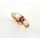 A yellow gold ruby opal & diamond ring, the central oval cushion cut ruby measuring approximately