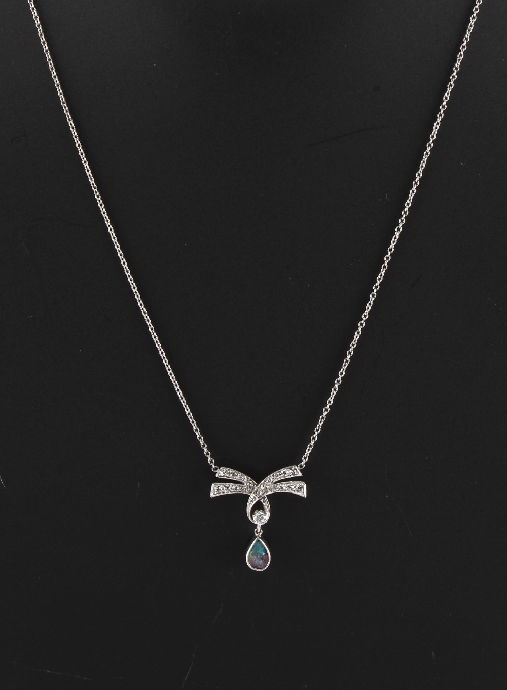 A black opal & diamond pendant on platinum chain necklace, the ribbon & pendant approximately 21mm