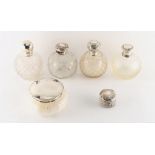 Four silver topped cut glass globe scent bottles, the tallest 5.75ins. (14.5cms.) high; together