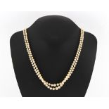A pearl two strand necklace, the largest pearl approximately 7mm diameter, with silver & marcasite