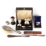 A box containing assorted small silver & silver mounted items including a cased Christening set.