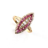 An 18ct yellow gold ruby & diamond navette shaped ring, set with a band of calibre cut rubies