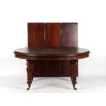 A Victorian mahogany oval topped telescopic wind-out extending dining table with three extra leaves,