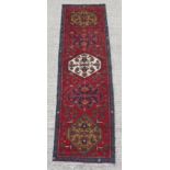 An Azari woollen hand-made runner, 113 by 33ins. (287 by 84cms.).