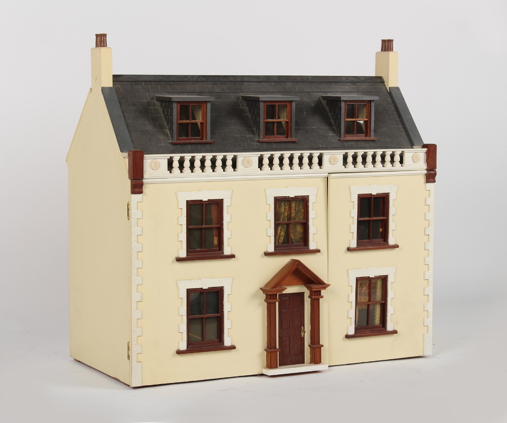 A large doll's house with furniture & furnishings, 31.5ins. (80cms.) long.