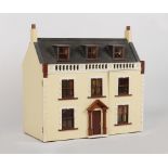 A large doll's house with furniture & furnishings, 31.5ins. (80cms.) long.