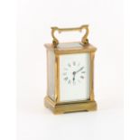 A W.J. Huber brass carriage clock timepiece, 5ins. (12.7cms.) high (with handle folded down).