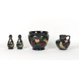 Four early 20th century Decoro pottery items comprising a planter, a ewer and a pair of garlic