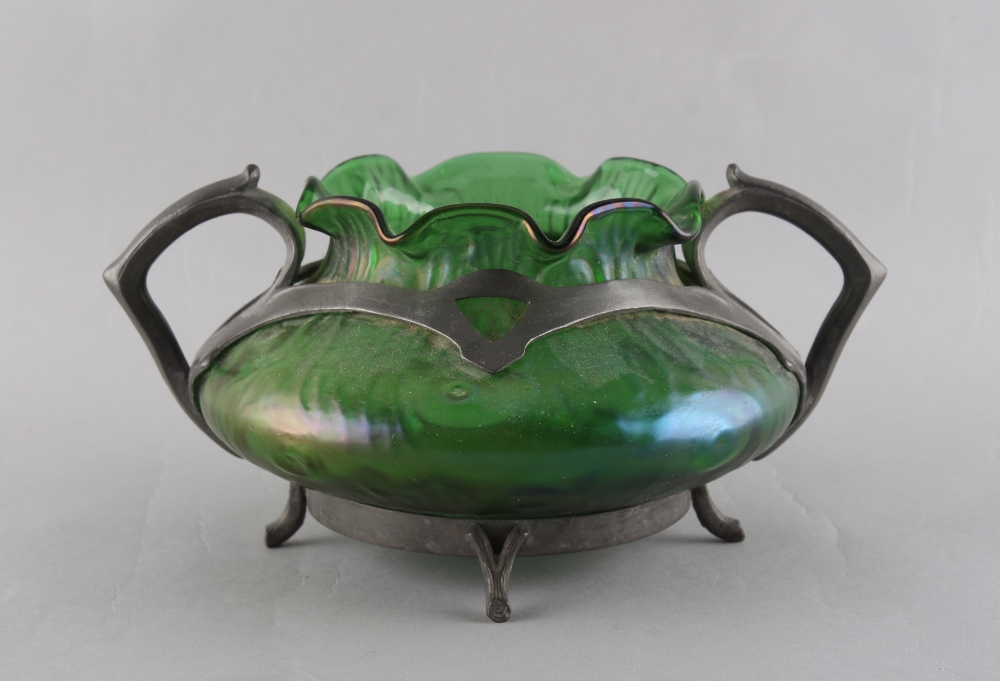 An early 20th century Art Nouveau pewter mounted green iridescent glass, the pewter foot rim