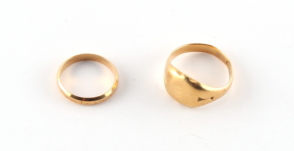 An 18ct gold signet ring; together with an 18ct gold wedding band (approximately 11.1 grams