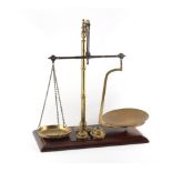 A set of Victorian brass & steel balance scales, by Bartlett, Bristol, on mahogany base, 17.5ins. (