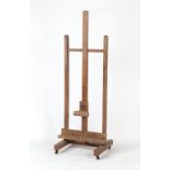 An early 20th century artist's beechwood adjustable easel.