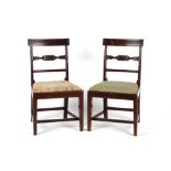 A pair of early 19th century George IV mahogany side chairs with carved backs (2).