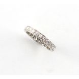An unmarked platinum diamond eternity ring, the twenty-four round brilliant cut diamonds weighing