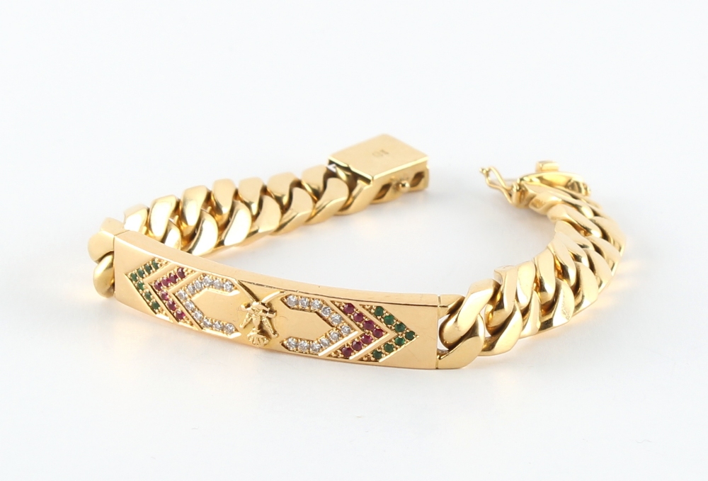 A heavy yellow gold identity type bracelet, marked 750, the panel set with diamonds, rubies &