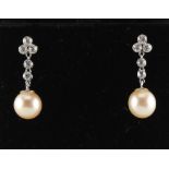 A pair of pearl & diamond earrings, with post & butterfly fastenings, each with a single untested