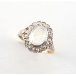 A yellow gold moonstone & diamond oval cluster ring, the oval moonstone measuring approximately 9 by