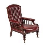 A Victorian mahogany & red leather upholstered armchair.