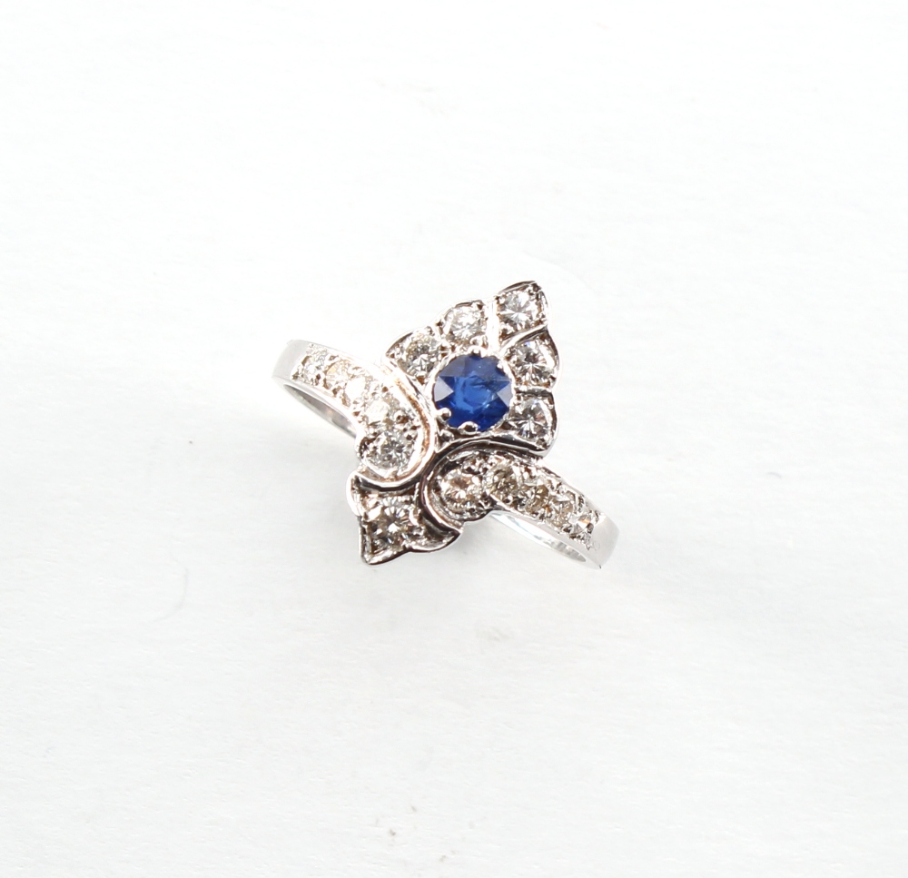 A Belle Epoque style white gold sapphire & diamond ring, the round cut sapphire weighing